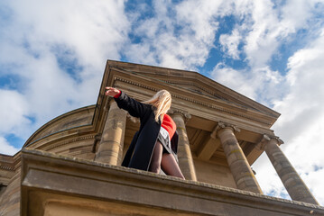 Woman with long hair enjoying the wind on a sunny winter day, low angle view