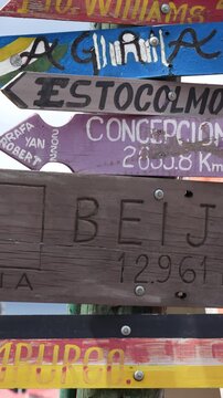 Colorful Signpost in Punta Arenas, Chile Showing World City Directions, Wanderlust and Journey Concept with International Direction Arrows