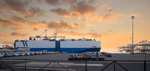 Close up vehicle carrier vessel loading car for shipping to worldwide, Large RoRo (Roll on off) vehicle car carrier, New car lined up in the port for import export around the world. © Rangsarit