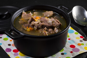 Chicken gizzards stewed with carrot in sauce.