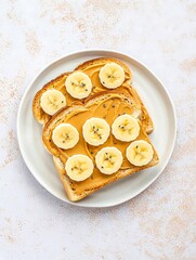 Delicious peanut butter banana toast on a white plate