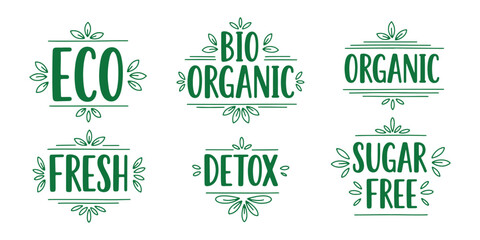Set of hand-drawn green typographic labels promoting eco-friendly, organic, and bio products with leaf accents