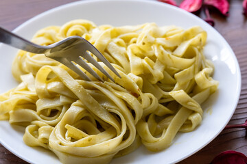 Close-Up of Creamy Pesto Tagliatelle Pasta
