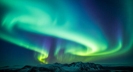 Scenic view of northern lights, vibrant green and blue aurora borealis shining above a snowy mountain range, representing natural beauty and wonder
