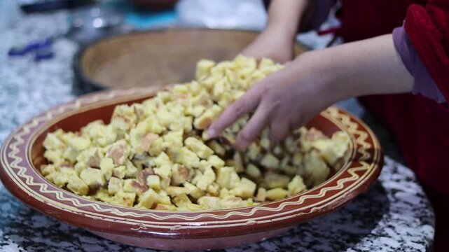 Moroccan Rfissa (Madhoussa) with Slow-Cooked Chicken, Lentils, Semolina Crumbles, and Herbs in Traditional Brown Ceramic Bowl with Garlic Garnish