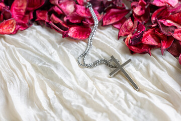 Close-Up of Dried Rose Petals and Metal Cross