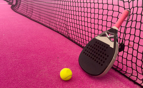A teal bag with a pink-gripped racket and a purple court