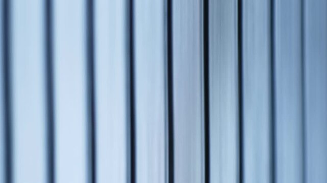 Blue striped metallic blue background texture in motion with shallow depth of field.