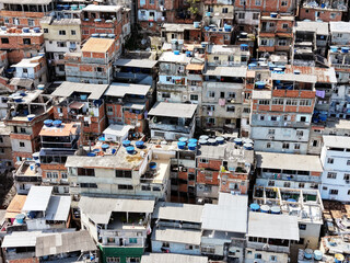 Aerial drone view of Favela Of Cantagalo, Rocinha favelas spread out on the mountain in Sao Conrado , Rio de Janeiro, Brazil.