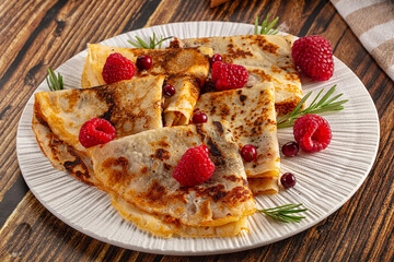 Sweet homemade pancakes with raspberry