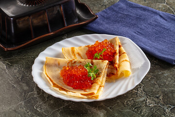 Russain traditional pancakes with red caviar