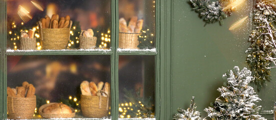 A banner photo of a display case featuring fresh baked goods at a French bakery. A concept for advertising bakery products. Copy space for the text