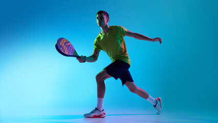 Padel athlete ready stance neon hybrid lighting. Concept of landing page sections, sports brand...