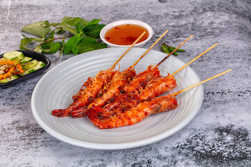 Grilled prawn skewer served sauce