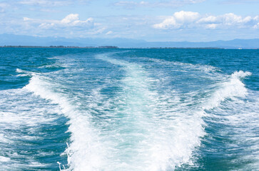 Bright Boat Wake in Sunlit Adriatic Sea Near Lignano Sabbiadoro, Italy