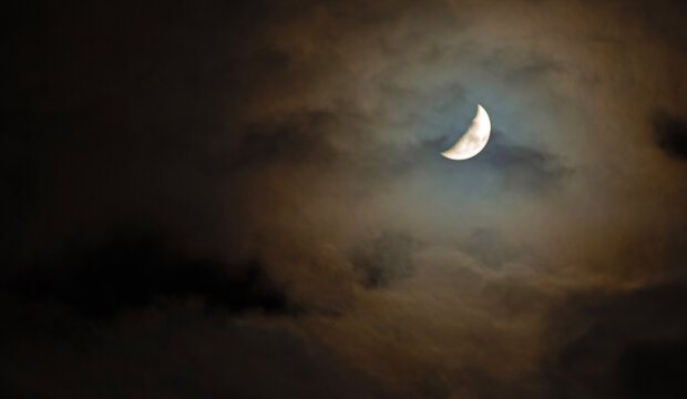Moon that seems to be parting the clouds at night