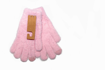 Pink fluffy children gloves on white background