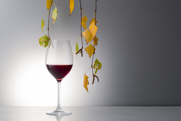 White wine bottle with autumn leaves