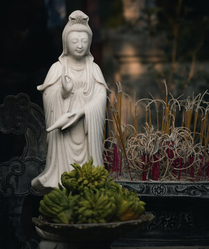 Prayer Shrine with a figurine and incense at the One Pillar Pagoda in Hanoi, Vietnam