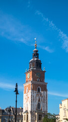 Town Hall Clock Tower on Main Square in the Old Town of Krakow. Old clock tower on a blue sky background