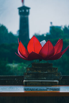 Close-up of a decorative lotus flower light with the Hanoi Flag Tower in the background. Photo taken from inside the imperial citadel of thang long.