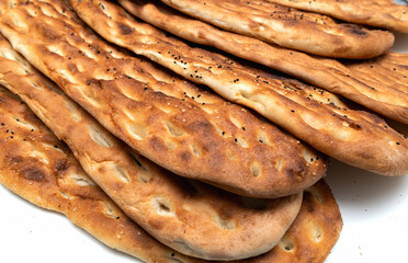 Warm middle eastern flatbread laid out in row.