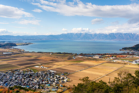 A stunning panoramic aerial view of the Omihachiman cityscape and autumn landscape from the Hachiman-yama Castle ruins. Omihachiman, Shiga, Japan.