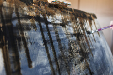 Abstract painting on canvas close-up. Paint drips.