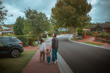 Fototapeta premium A happy family walking joyfully handinhand in a peaceful neighborhood setting
