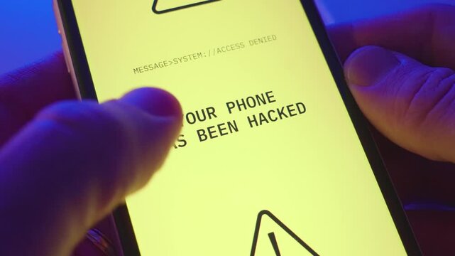 Close up on phone alert or message announcing device is hacked and access denied. Person holding mobile phone receives notification warning of malware or virus locked system and breached its security