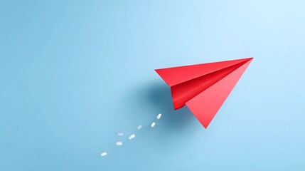 Symbolic representation of a red paper airplane in flight on a simple blue backdrop indicating progress ambition and the launch of new ideas or journeys