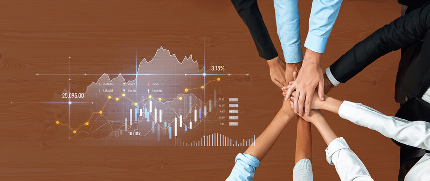A dynamic scene of teamwork focused on financial analysis, with hands joined together on a wooden table, showcasing data with charts in a modern office environment. Scalp - Powered by Adobe