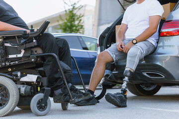Two friends are enjoying time together outside a car, one in a power wheelchair and the other with...