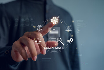Business professional touching virtual compliance interface with audit, regulation, data security and governance icons, illustrating digital risk management and corporate control systems.