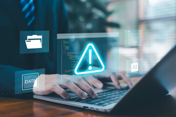 Cybersecurity alert concept showing a professional using a laptop with digital warning icon, data protection interface, technology, code overlay, representing cyber threat detection, network security,