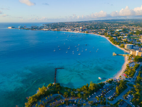 Pebbles Beach aerial view at sunset at Carlisle Bay in city of Bridgetown, Saint Michael, Barbados. This coast belongs to Bridgetown and Garrison UNESCO World Heritage Site. 