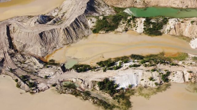 Waste rock dumps, artificial lakes in ilmenite quarry, aerial view