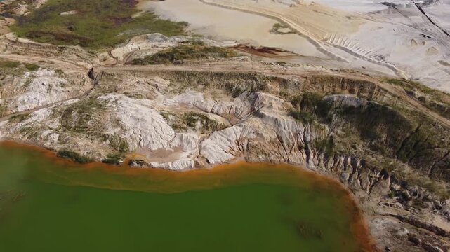 Waste rock dumps, artificial lakes in ilmenite quarry, aerial view