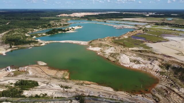Waste rock dumps, artificial lakes in ilmenite quarry, aerial view