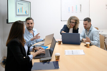 Business colleagues collaborating on business strategy with laptops