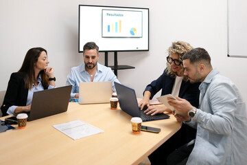 Business team analyzing results during office meeting