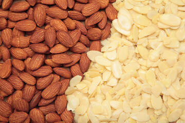 Fresh almond flakes and nuts background