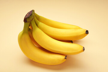 Bunch of bananas on beige background. Top view