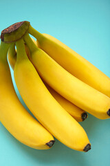 Bunch of bananas on mint background. Top view. Vertical photo