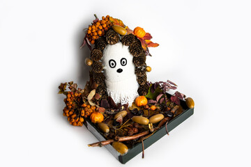 Handmade mythological wood-goblin created ifrom stump and pine needles. Troll is surrounded by moss and stones, looks authentically and funny