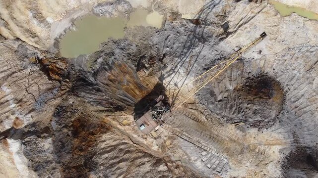Boom walking excavator digs ilmenite ore stratum in quarry