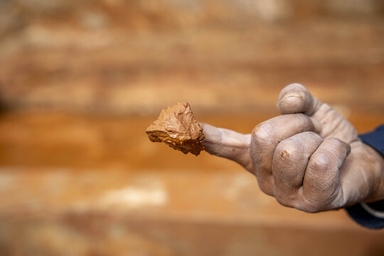 Worker with clay on a finger in a pottery workshop, Safi, Morocco
