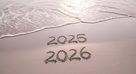 New year numbers written in sand on beach by ocean waves at sunset