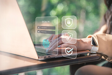 Secure Login and Biometric Authentication on Laptop, A close-up view of a user typing on a laptop with a transparent digital sign in interface overlay, featuring username and password fields.