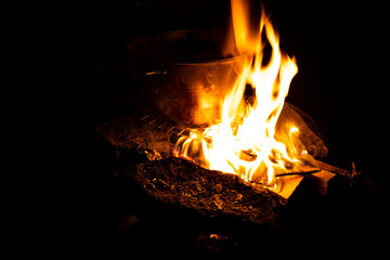 Cooking on the fire for a camping trip. Pot over a fire outdoors. The romance of the wild tourism and food in camp. Backpacking on the nature at sunset. 